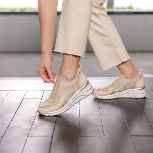 Model wearing the Remonte D0T08 women's slip-on sneaker, demonstrating easy zip closure and casual athleisure style.