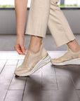 Model wearing the Remonte D0T08 women's slip-on sneaker, demonstrating easy zip closure and casual athleisure style.