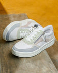Women's Remonte D0J01 lace-up sneakers in pastel colors displayed on wooden steps, showcasing stylish design and side zipper detail.