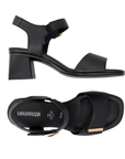 Pair of Black block heel sandals with gold accents on Velcro Straps, black Remonte logo'd footbed and black outsole.