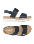Pair of Backstrap Sandals in navy with gold accents, two Velcro straps, tan Remonte logo'd footbed, faux jute and white platform midsole and lugged white outsole.