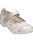 Beige Mary Jane shoe with gold accents and a off-white outsole.