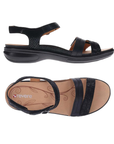 Pair of Black strappy sandals with textured accent straps, circle buckle detail, tan Revere logo'd footbed and black outsole.