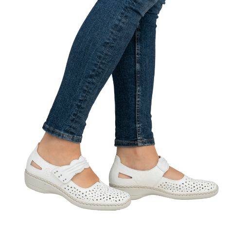 Women in blue jeans wearing white perforated Rieker Mary-Janes.