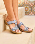 Blue Women's Rieker 608K2 Slide Sandals worn outdoors, highlighting their elegant design and comfort for summer outings.