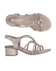 Pair of Gold sandals with sparkly criss-crossing straps, tan Rieker logo'd footbed and gold block heel.