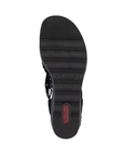 Black light treaded outsole of wedge sandal with red Rieker logo on heel.