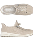Pair of Beige sneakers with white bungee lacing, pale shimmery wording accents over upper and a grey outsole.