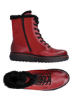 Pair of red suede and smooth leather mid calf boots with fur lining and cuff, laces, and inside zipper.