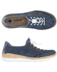 Pair of navy blue slip on sneaker with rainbow side accent rainbow stitching, white bungie closure and faux cork midsole and white outsole.