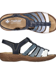 Pair of Navy blue sandals with fading lighter blue straps, gladiator style upper, tan Rieker logo'd footbed and brown outsole.