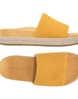 Pair of amber yellow suede slide espadrille sandals with Vionic logo'd tan footbed.