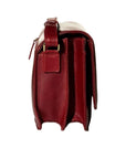 Profile view of the 3/4 flap organizer bag in whiskey. Buckles and zippers are bronze.