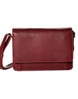 3/4 flap organizer bag in whiskey. A reddish-brown leather bag with a flap closure and an adjustable shoulder strap.