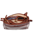 Top view of a brown leather purse, displaying the organizational features inside one of the compartments, which holds credit cards, a cellphone, and a pen.