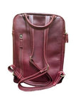 Rear exterior of burgundy leather backpack, showing adjustable shoulder straps, handle, and two vertical zippered compartments.