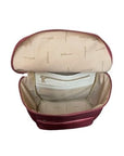Interior of burgundy backpack, showing beige lining and zippered pockets.