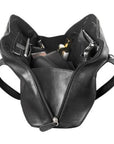 Interior of black full zip handbag, showing the black lining and trim. Bag contains cellphone, a wallet, cosmetics, a pen, a passport, and other items.