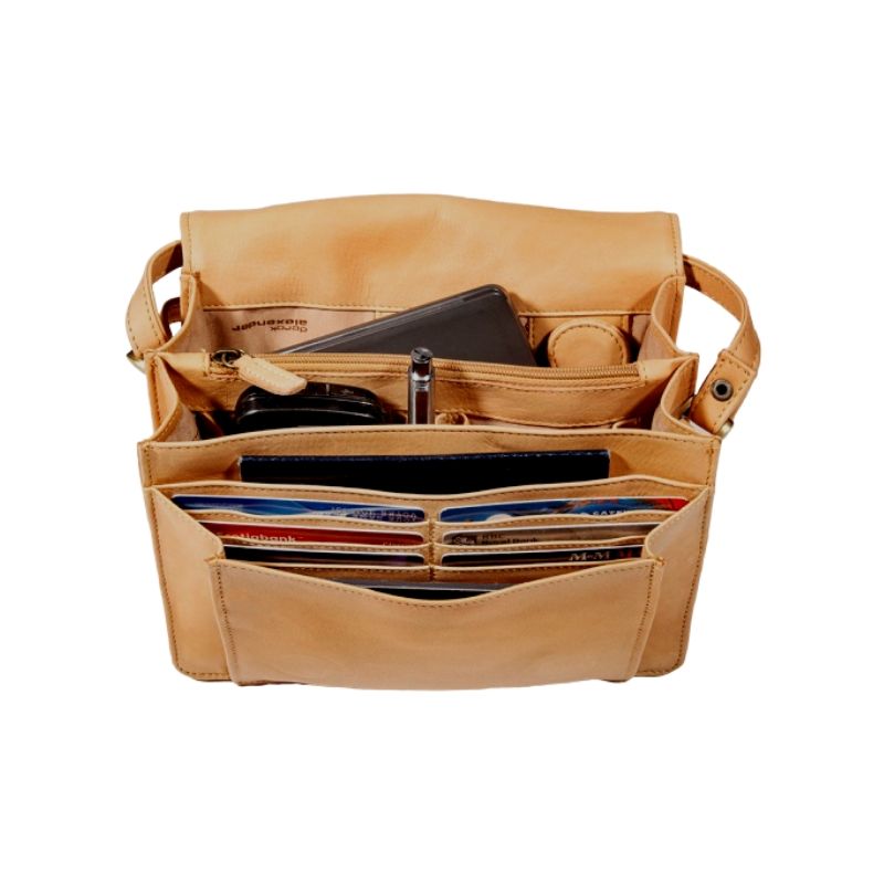 Interior of the 3/4 flap organizer bag in Buffalo, which contains a cellphone, key ring, a pen, a passport, and many credit cards across multiple compartments.