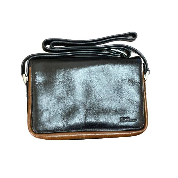 Black leather handbag with brown trim and an adjustable shoulder strap. Derek Alexander logo is embossed on the bottom corner.