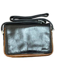 Black leather handbag with brown trim and an adjustable shoulder strap. Derek Alexander logo is embossed on the bottom corner.
