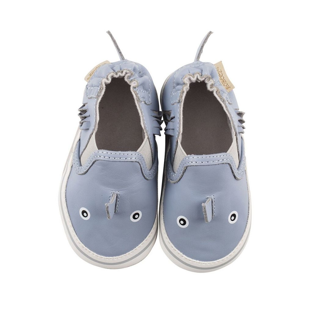 Looking down on  blue leather 3D shark kids shoe.