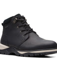 Ankle height winter boot with black leather upper, white midsole, and black outsole. Features lace closure with silver hardware.