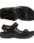 A pair of Ecco Yucatan black and khaki coloured nubuck sandals with orange accents on velcro heel, instep and toe straps. Footbed, midsole, and outsole are black.