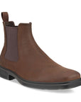 An Ecco Chelsea boot with a brown nubuck upper with a black outsole and dark brown elastic goring.