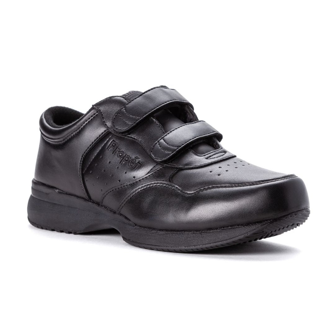 Black sneaker with 2 velcro straps and perforated sections with a thick outsole