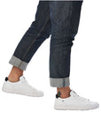 Model wearing Men's Rieker 07102 Lace Sneaker with rolled jeans, demonstrating the sneaker's casual style and comfortable fit for everyday use.