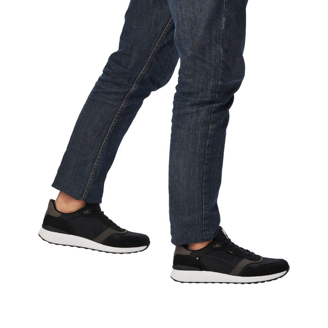 Model wearing Men's Rieker 07602 Slip On Sneaker with jeans, highlighting casual style and supportive fit for everyday wear.