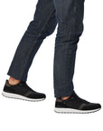 Model wearing Men's Rieker 07602 Slip On Sneaker with jeans, highlighting casual style and supportive fit for everyday wear.