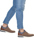 Tan casual shoes worn with light jeans.