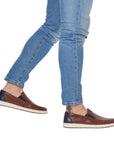 Model wearing brown Men's Rieker 18266 Loafers with blue jeans, ideal for casual summer outings with lightweight comfort.