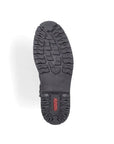 Close-up of Rieker F3600 black boot outsole with deep traction lugs and red Rieker logo, designed for grip in winter conditions.