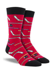 A pair of red crew socks with hockey sticks and pucks on them.