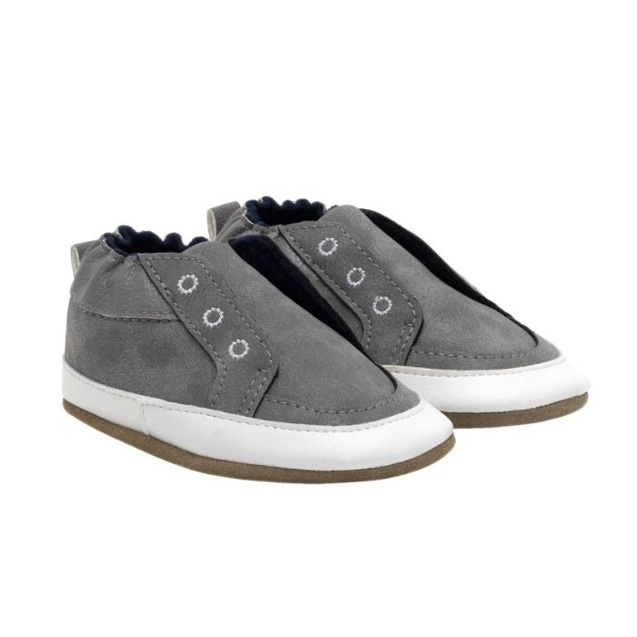 Grey leather baby shoes with fake eyelets stitched on.
