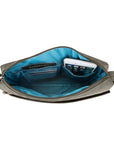 Interior view of Travelon Anti-Theft Small E/W Crossbody showing organized compartments for phone, passport, and cards in blue lining.