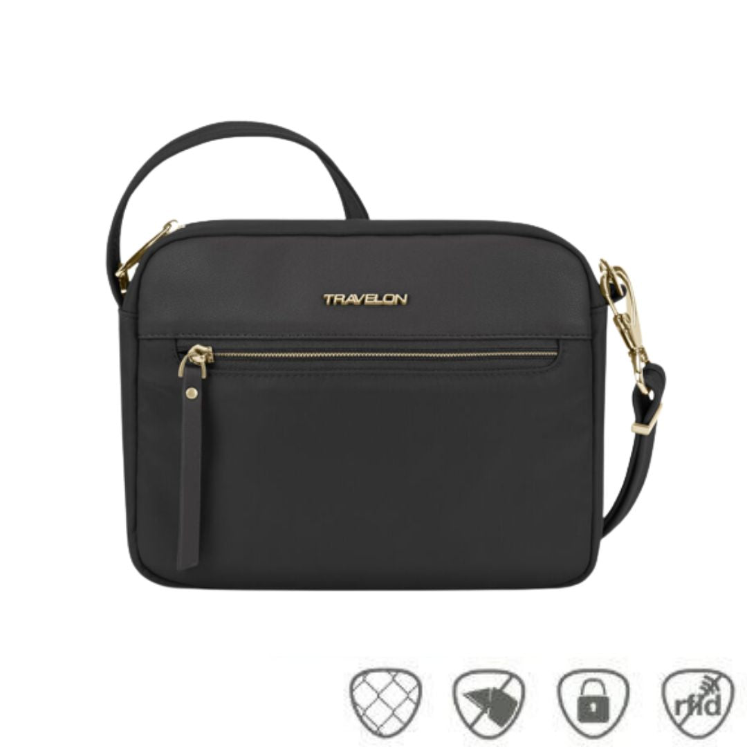 Black crossbody bag with gold Traelon emblem. Horizonal gold zipper is on the front.
