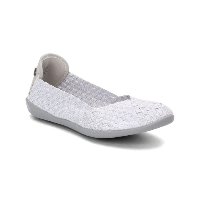 The Bernie Mev Catwalk flat in white silver metallic. The woven elastic upper is white with silver accents and the outsole is grey. A small silver medallion with Bernie Mev branding is visible on the back of the heel. 