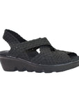 A black Bernie Mev Lihi Brighten sandal with woven elastic upper, a heel strap, an open toe and a black wedge outsole.