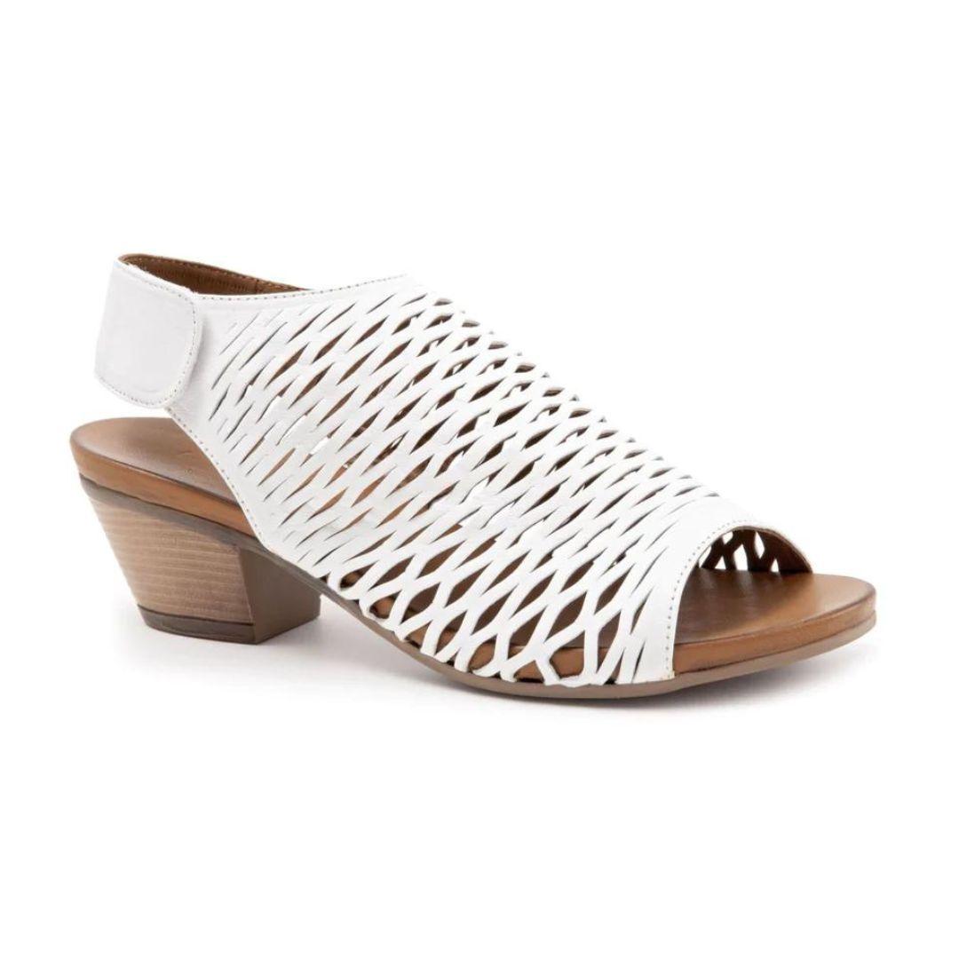 Lacey heeled sandal in white. Perforated white leather upper with velcro backstrap, brown leather footbed, and a 2 inch block heel.