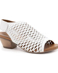 Lacey heeled sandal in white. Perforated white leather upper with velcro backstrap, brown leather footbed, and a 2 inch block heel.