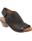 Lacey heeled sandal in black. Black leather perforated upper with velcro backstrap. Footbed is brown leather, with a 2 inch stacked heel.