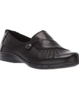 Paulette loafer in black. A black slip on shoe with gathered leather detailing and a decorative silver button.