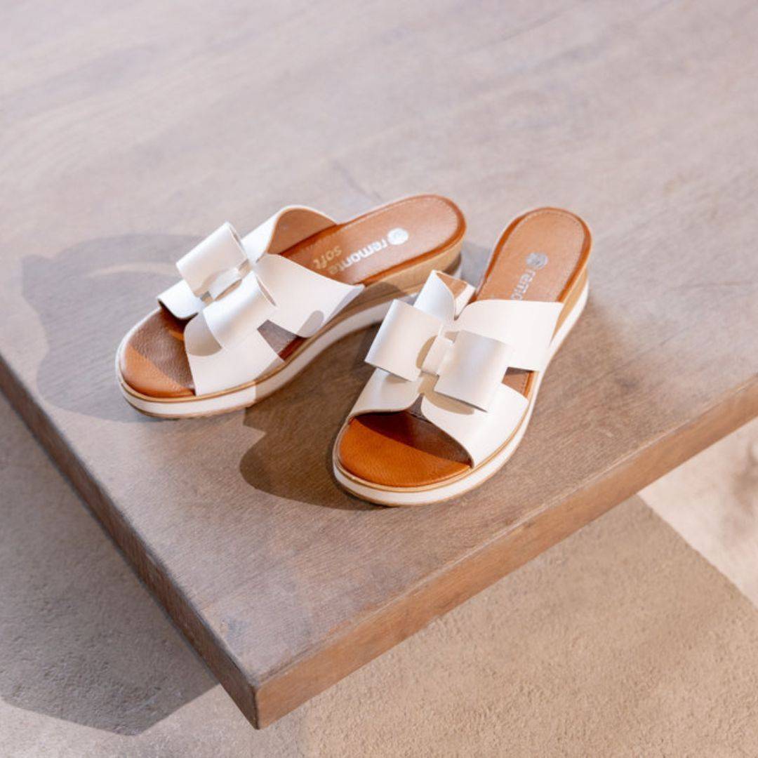 White Rieker D6456 women's platform wedge sandals displayed on wooden surface, showcasing elegant and casual summer footwear.