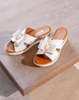 White Rieker D6456 women's platform wedge sandals displayed on wooden surface, showcasing elegant and casual summer footwear.