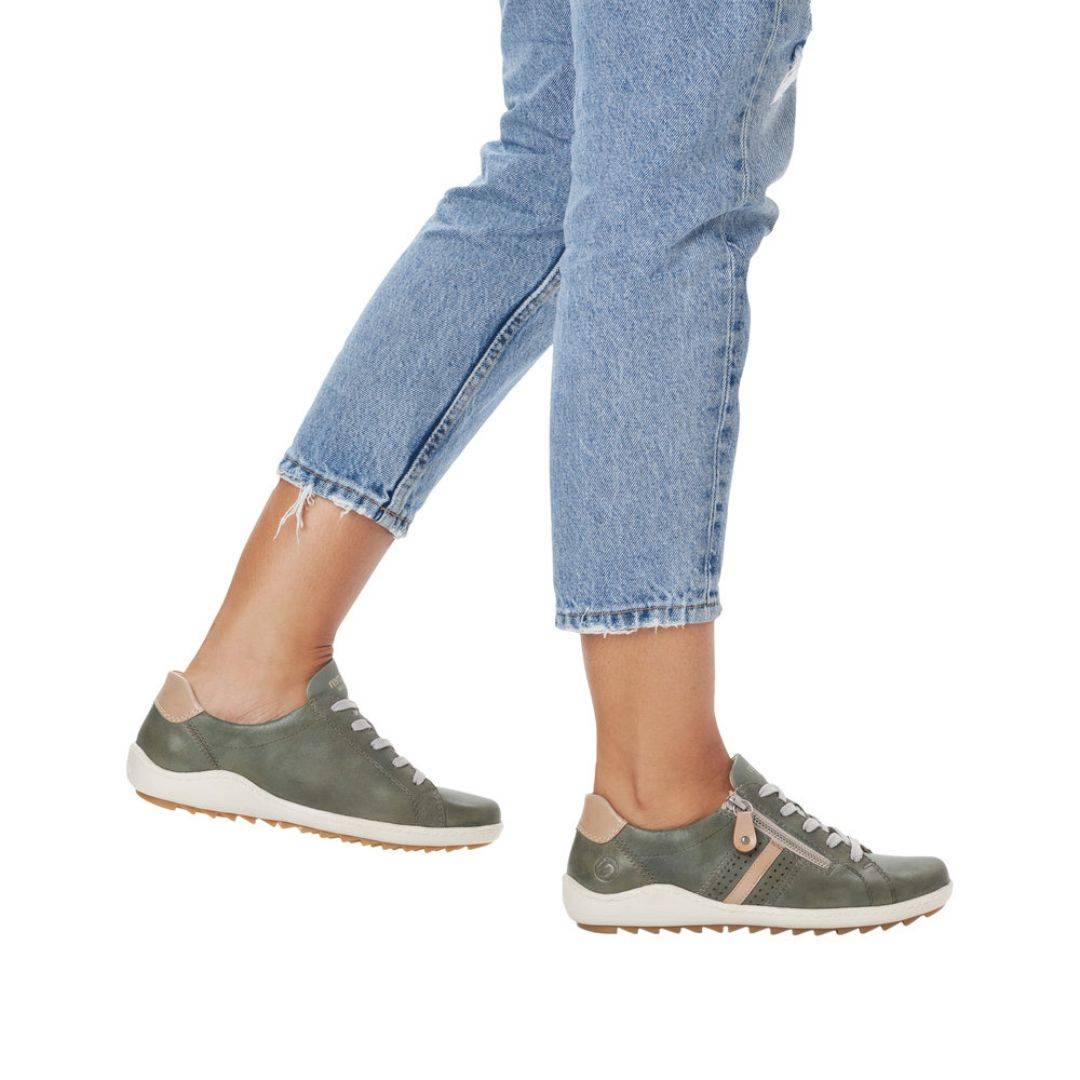 Model wearing green Women's Remonte R1432 Lace-Up Sneakers with jeans, demonstrating casual style and lightweight comfort.
