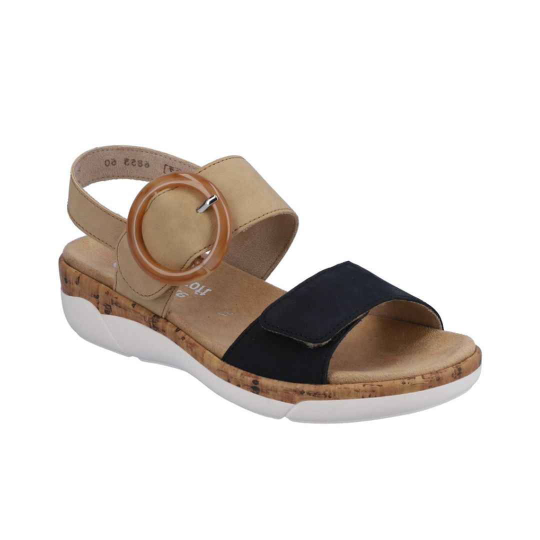 Rieker R6853 Backstrap Sandal in tan and black with oversized buckle, adjustable straps, and shock-absorbing sole for women’s summer wear.